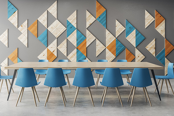 Long table and blue empty chairs set up for a corporate meeting